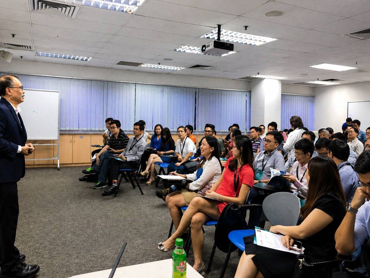 Packed-room audience at a corporate seminar